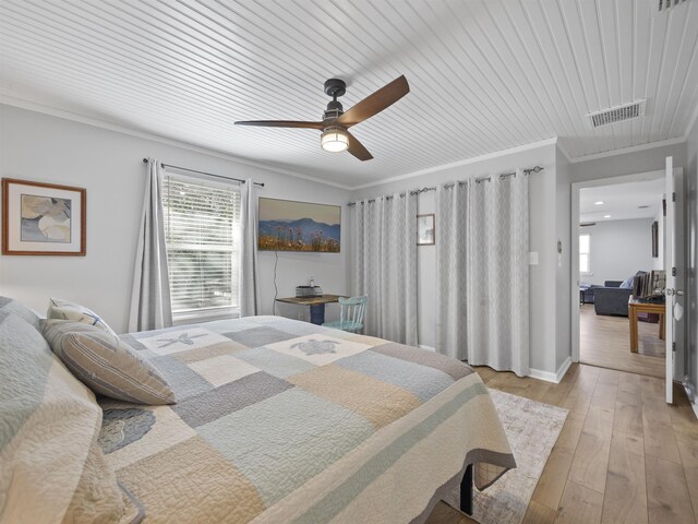 bedroom with ceiling fan, light wood-type flooring, crown molding, and wood ceiling