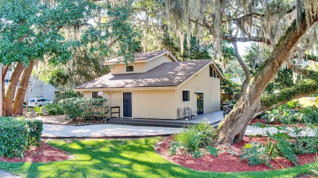 rear view of property with a yard