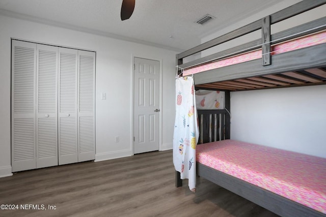 bedroom featuring ceiling fan, a textured ceiling, and dark hardwood / wood-style flooring