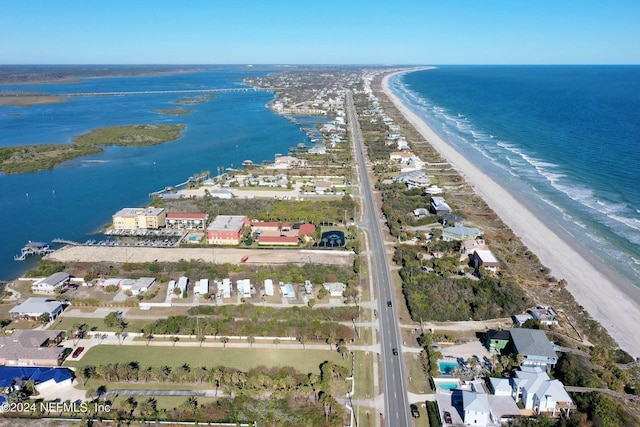 drone / aerial view featuring a water view and a beach view