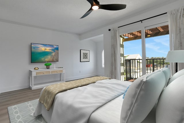 bedroom featuring hardwood / wood-style flooring, ceiling fan, multiple windows, and access to outside