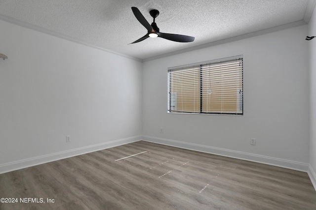 spare room featuring ceiling fan, crown molding, a textured ceiling, and light wood-type flooring