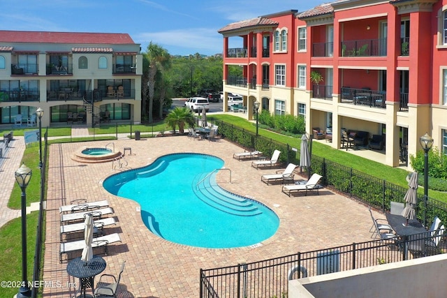 view of pool featuring a community hot tub and a patio