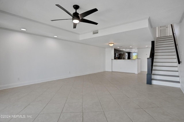 unfurnished living room with ceiling fan and light tile patterned flooring