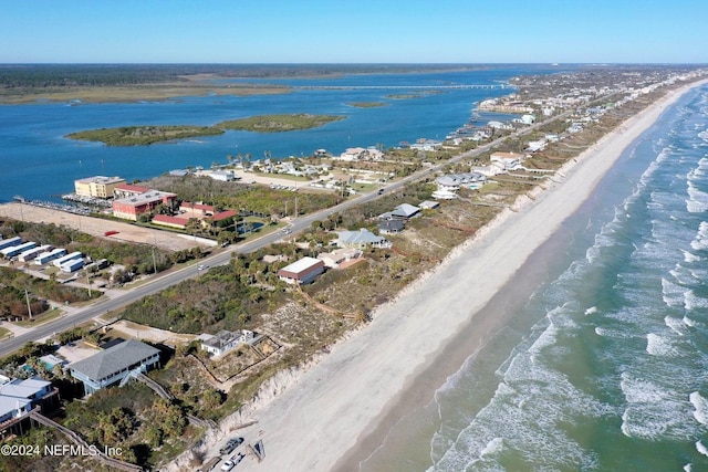 drone / aerial view featuring a water view and a view of the beach