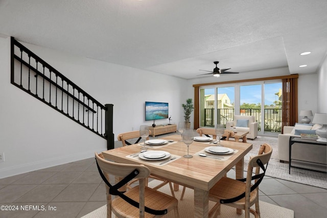 dining room featuring a textured ceiling, tile patterned floors, and ceiling fan