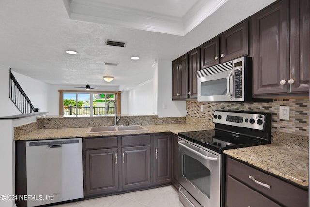 kitchen with crown molding, appliances with stainless steel finishes, sink, and dark brown cabinets