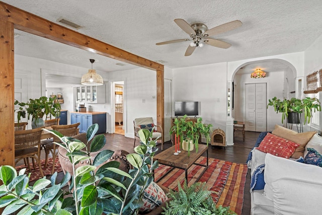 29 Oak St, Saint Augustine, FL 32084 - living area featuring arched walkways, a ceiling fan, a textured ceiling, and dark wood finished floors