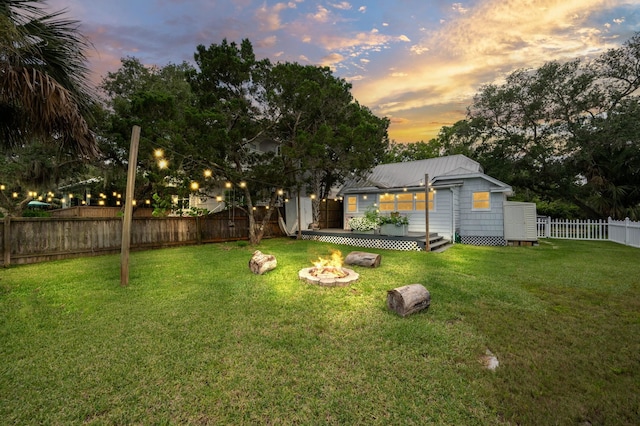 29 Oak St, Saint Augustine, FL 32084 - yard at dusk featuring an outdoor fire pit and a wooden deck