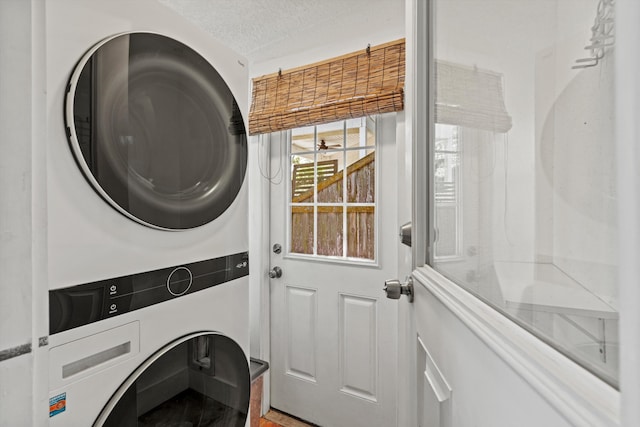 29 Oak St, Saint Augustine, FL 32084 - washroom featuring stacked washer and clothes dryer and a textured ceiling