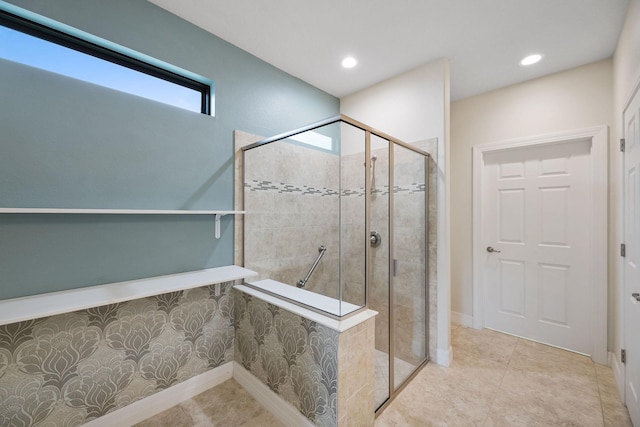 bathroom featuring tile patterned flooring and a tile shower