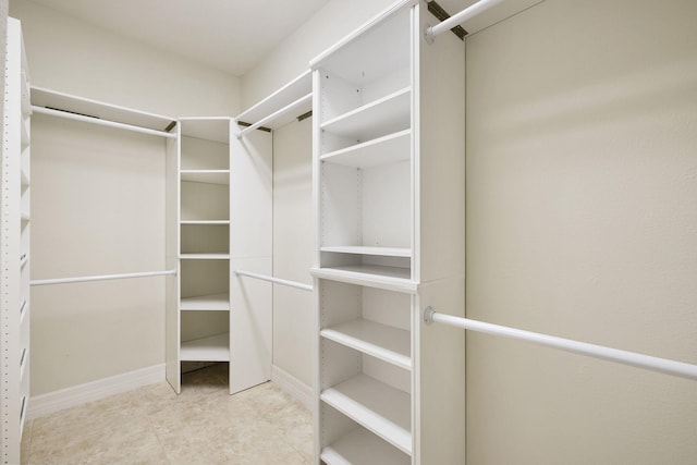 walk in closet with tile patterned floors