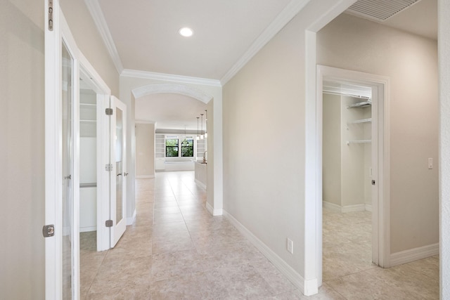 797 Wild Cypress Cir, Ponte Vedra, FL 32081 - hall featuring crown molding, arched walkways, light tile patterned flooring, and french doors