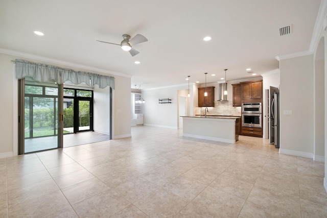 unfurnished living room with sink, ceiling fan, crown molding, and light tile patterned flooring