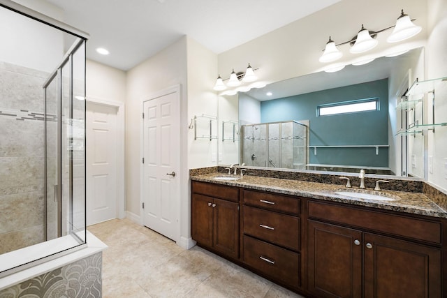 bathroom with tile patterned flooring, vanity, and a shower with shower door