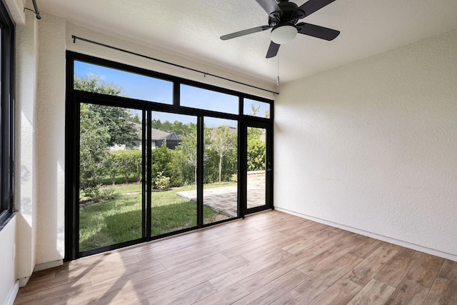 empty room featuring light wood-type flooring and ceiling fan