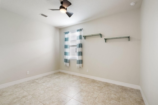 empty room featuring ceiling fan and light tile patterned flooring