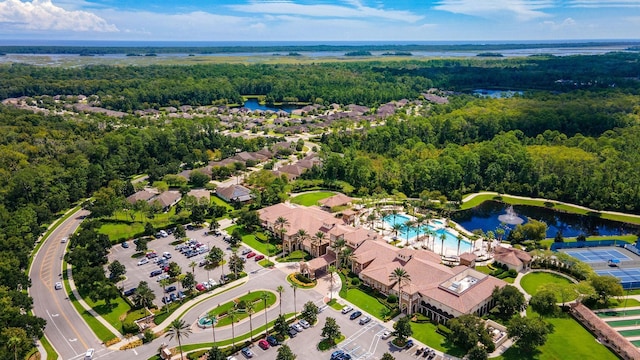 birds eye view of property with a water view and a forest view