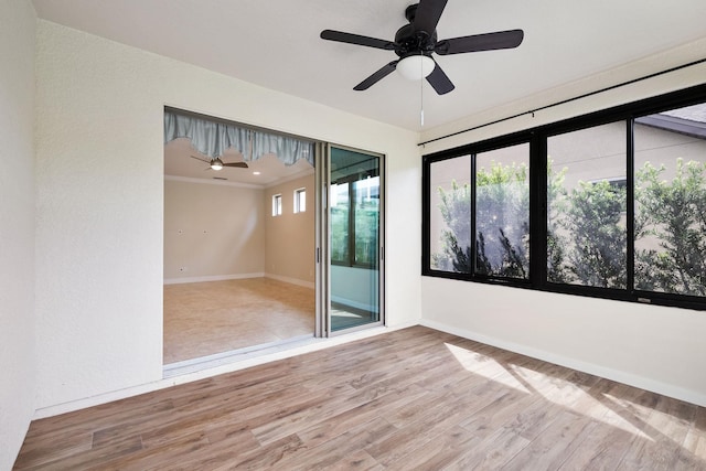 unfurnished room with ceiling fan, wood-type flooring, and crown molding