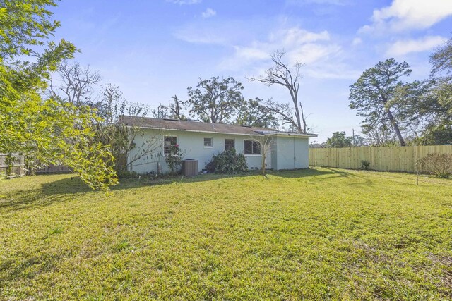 back of house with a lawn and fence private yard