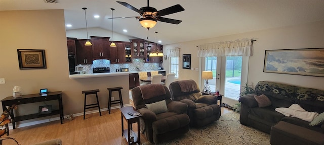 living room featuring light hardwood / wood-style flooring, ceiling fan, and lofted ceiling