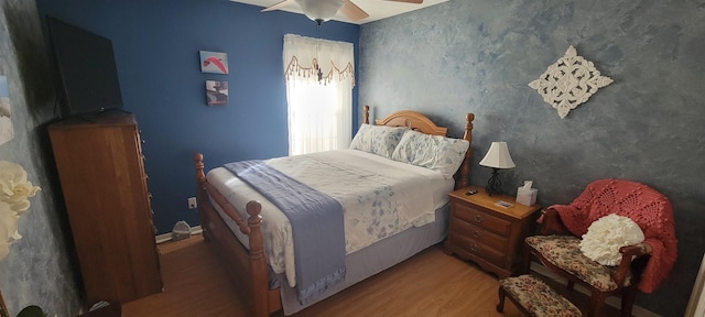 bedroom featuring ceiling fan and dark wood-type flooring