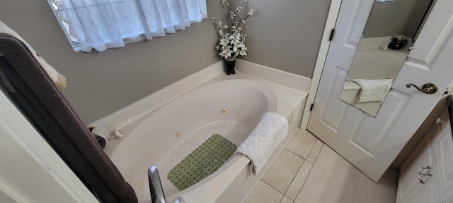 bathroom featuring tile patterned flooring and a tub to relax in