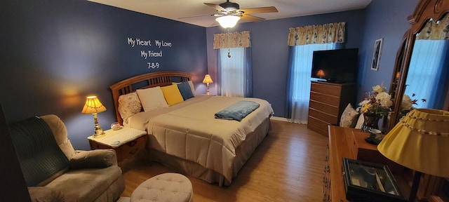 bedroom with hardwood / wood-style flooring and ceiling fan