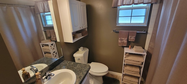 bathroom featuring vanity, a shower with shower curtain, and toilet