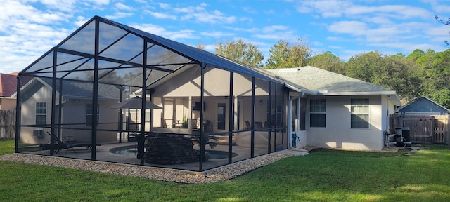 rear view of house featuring a lanai, a patio area, a lawn, and a pool