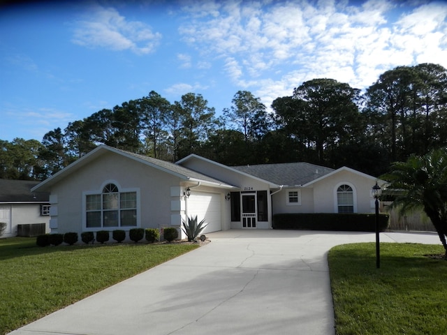 ranch-style house featuring a front yard and a garage