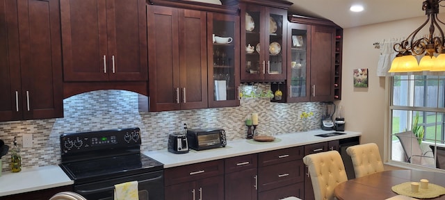 kitchen with tasteful backsplash, black electric range oven, and hanging light fixtures