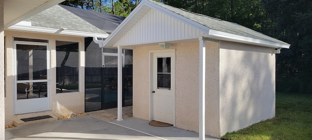 view of exterior entry featuring a patio