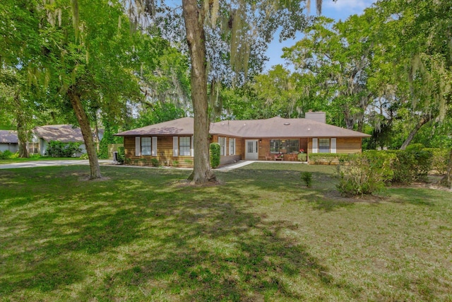 200 Raintree Trl, Saint Augustine, FL 32086 - ranch-style house with a chimney and a front yard