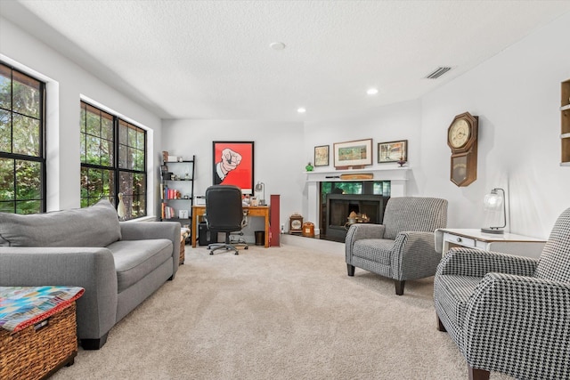 200 Raintree Trl, Saint Augustine, FL 32086 - home office featuring light colored carpet, a lit fireplace, a textured ceiling, and recessed lighting