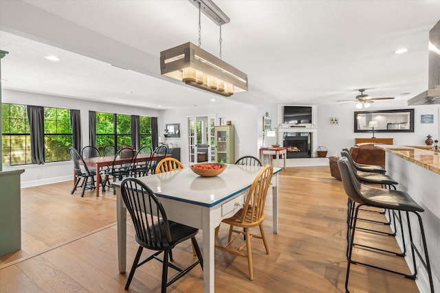 200 Raintree Trl, Saint Augustine, FL 32086 - dining room with a warm lit fireplace, healthy amount of natural light, light wood-style floors, ceiling fan, and recessed lighting