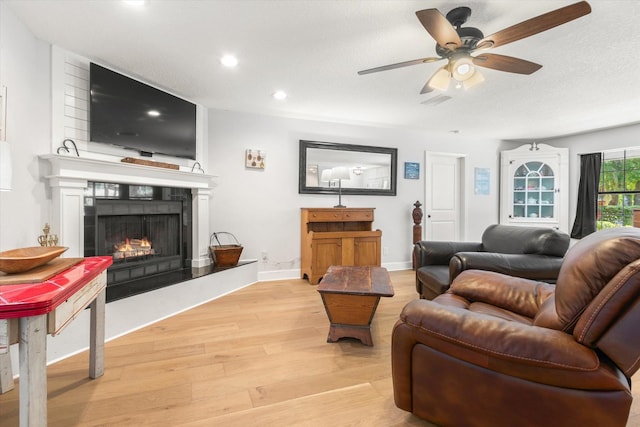 200 Raintree Trl, Saint Augustine, FL 32086 - living area featuring light wood-type flooring, a ceiling fan, a lit fireplace, and recessed lighting
