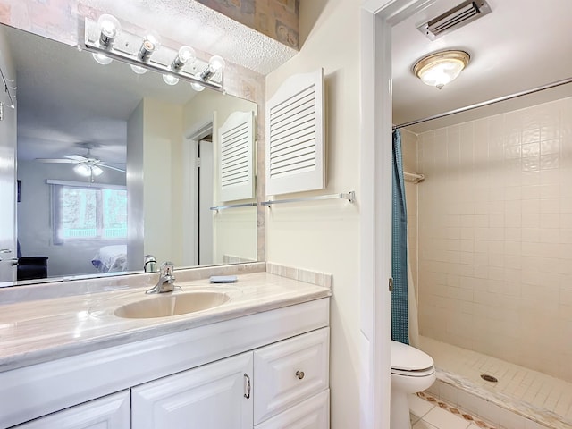 bathroom featuring tile patterned flooring, toilet, ceiling fan, and curtained shower