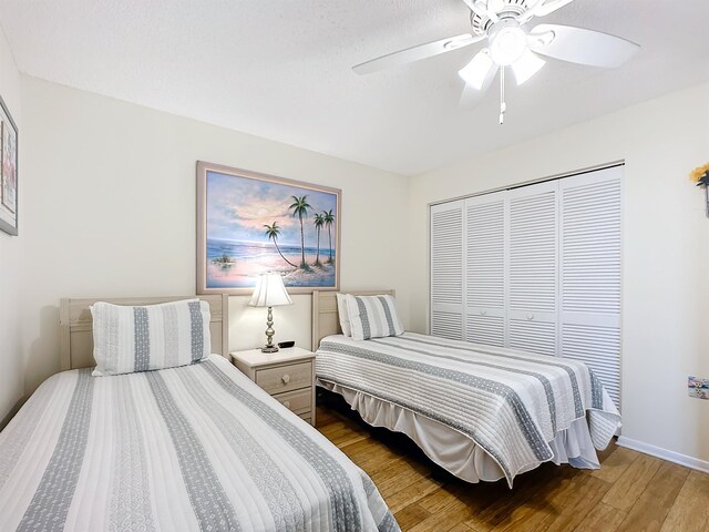 bedroom with a closet, ceiling fan, and hardwood / wood-style floors