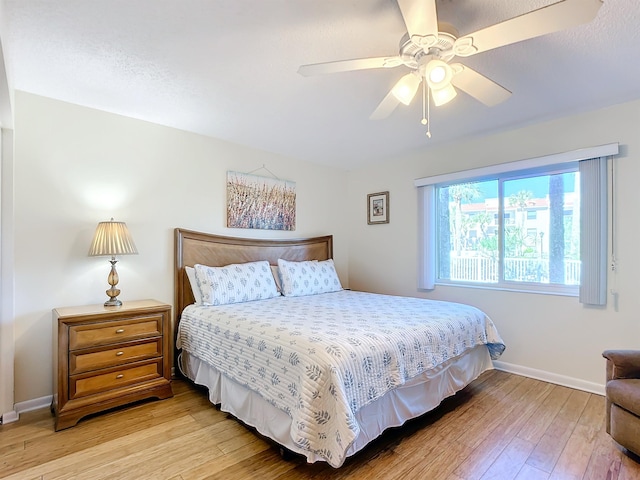 bedroom with hardwood / wood-style flooring and ceiling fan