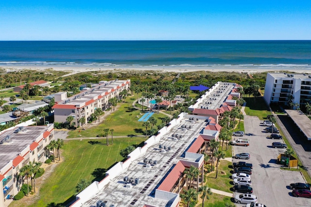 bird's eye view with a water view and a beach view