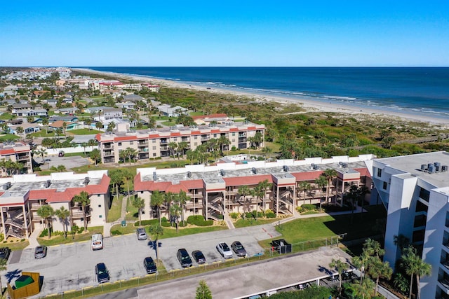 birds eye view of property featuring a beach view and a water view