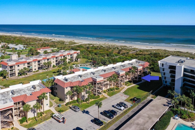 drone / aerial view featuring a view of the beach and a water view