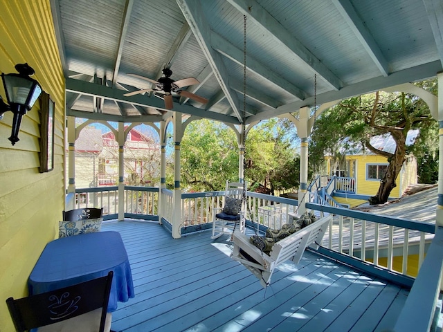 deck featuring ceiling fan and an outdoor structure