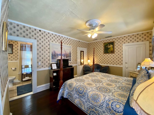 bedroom with ceiling fan, connected bathroom, ornamental molding, and dark hardwood / wood-style flooring