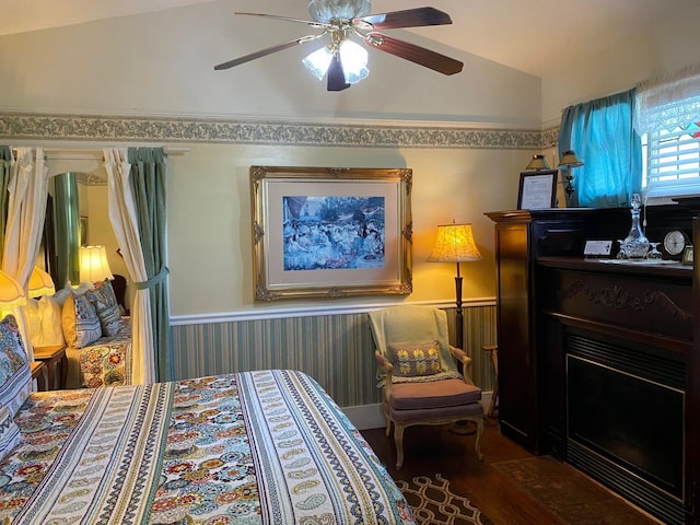 bedroom with hardwood / wood-style floors, vaulted ceiling, and ceiling fan