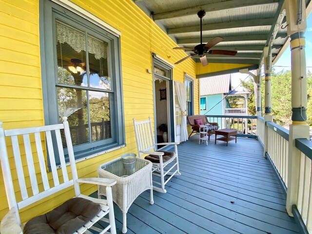 deck with covered porch and ceiling fan