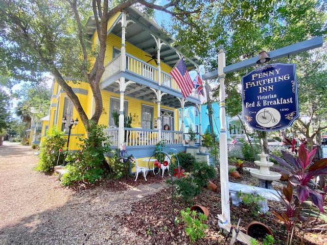 exterior space featuring a balcony, covered porch, and ceiling fan