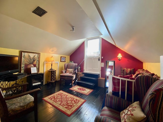 living room with dark wood-type flooring and lofted ceiling