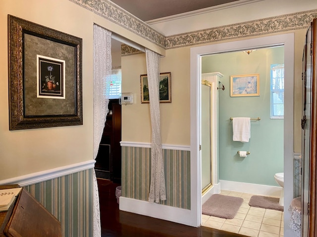 hallway with crown molding and tile patterned flooring